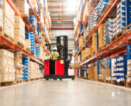 Worker operating a forklift in a distribution warehouse