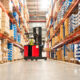 Worker operating a forklift in a distribution warehouse