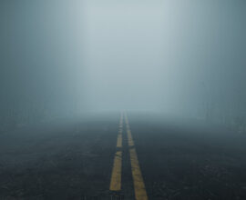 Misty, foggy road representing uncertainty and unpredictability