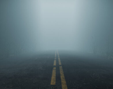 Misty, foggy road representing uncertainty and unpredictability