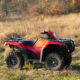 Red quad bike parked in a paddock