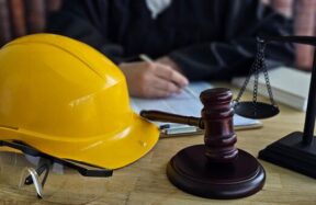 Courtroom setting with construction hat and gavel - workplace prosecution