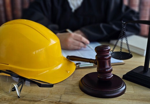Courtroom setting with construction hat and gavel - workplace prosecution
