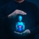Human hands protecting AI robot hologram - responsible artificial intelligence