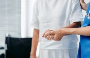 Healthcare worker providing assistance to elderly patient in care facility