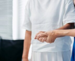 Healthcare worker providing assistance to elderly patient in care facility