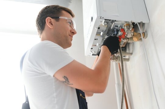 Professional technician checking natural gas boiler - qualified boiler service