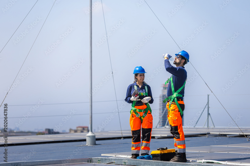 Worker installing solar panels on residential roof without fall protection