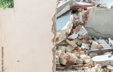Fallen brick wall at a construction site caused by wind