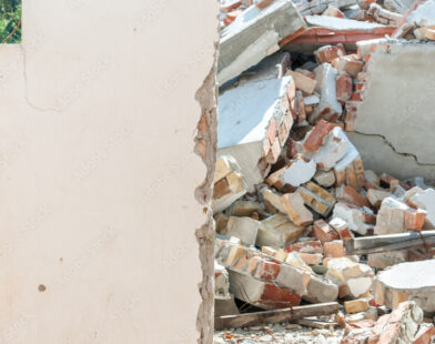 Fallen brick wall at a construction site caused by wind