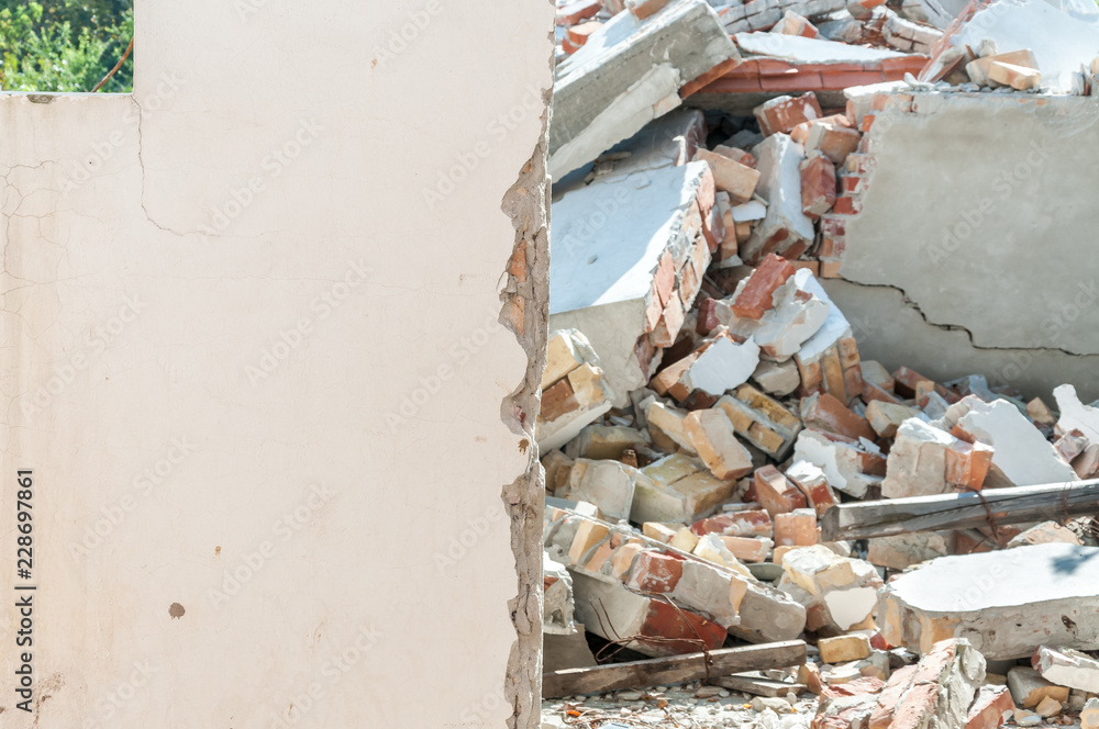Fallen brick wall at a construction site caused by wind